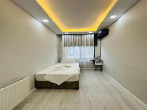 a bedroom with a bed in a room with a window at Kosova Hotel in Istanbul