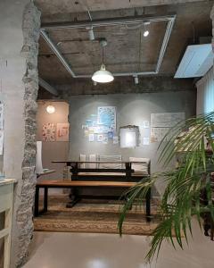 a room with a bench in front of a wall at Chuncheon Diary Stay in Chuncheon