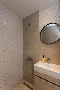 a bathroom with a sink and a mirror at Tsimiski double suites #8 in Thessaloniki