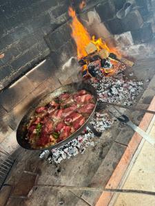 a pan of food is cooking in an oven at Apartman Šimić in Gračac