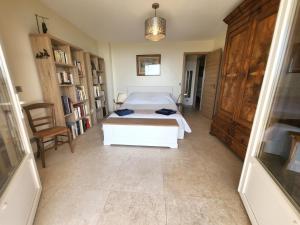 a bedroom with a bed and a book shelf at "La Colombe sous les Oliviers" Gîte jusqu'à 4 personnes - 75m2 - Sur Boooking - Rez de jardin Piscine Vue mer et lac in Spéracèdes +41 photos