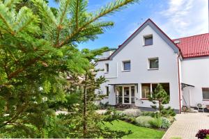 a white house with a red roof at Vilaverona in Palanga