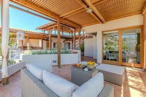 an outdoor living room with couches and a patio at Platanias Memories Apartment in Platanias