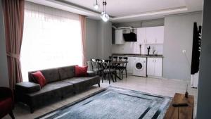 a living room with a couch and a kitchen at New Armila Suites in Trabzon