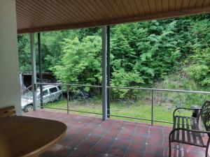 a screened porch with a view of a car parked on the grass at Rent Olamit in Šančiai