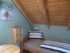 a bedroom with a bed and a wooden ceiling at Haus Peenehagen in Groß Gievitz