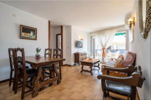 a living room with a wooden table and chairs at Mexico I in Cambrils