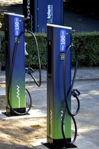 two blue and green gas pumps on a street at KYRIAD HONFLEUR - La Riviere Saint Sauveur in Honfleur