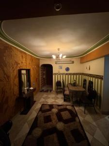 a living room with a table and chairs and a ceiling at Apartment in assiut with AC in Al Walīdīyah
