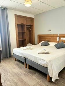 a bedroom with a large bed in a room at H&ocirc;tel Sans Souci in Jausiers