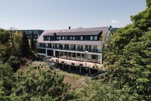 a large building on a hill with trees at Si-View Doppelzimmer Siegen Zimmer 15 - Hotel in Siegen