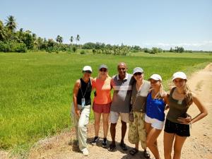 a group of people standing in front of a field at Kithmi Resort in Polonnaruwa