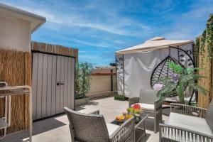 a patio with a table and chairs and an umbrella at סוויט-הוט in Safed +5 photos