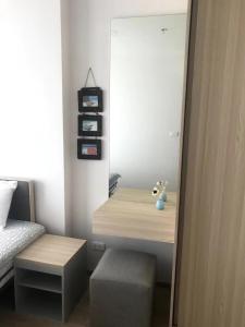 a bedroom with a bed with a mirror and a stool at Owow o2 in Bang Chak +8 photos