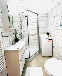 a bathroom with a shower and a toilet and a sink at Comfy Luxury Apartment with 2 rooms in the City Centre AA in Budapest