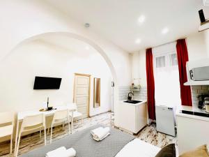 a living room with a table and a kitchen at Comfy Luxury Apartment with 2 rooms in the City Centre AA in Budapest