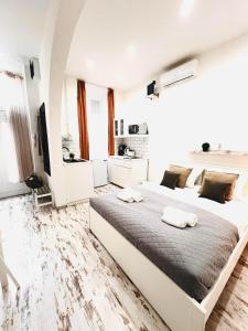 a bedroom with a large bed with two towels on it at Comfy Luxury Apartment with 2 rooms in the City Centre AA in Budapest