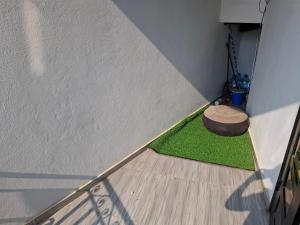 a corner of a room with a patch of grass at cosyhome 2 in Douala