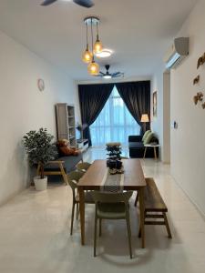 a living room with a table and chairs and a couch at Foo homestay @setia sky88 in Johor Bahru