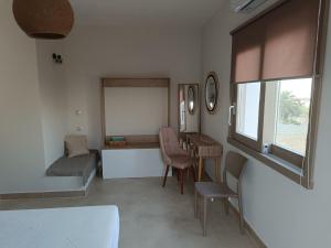 a room with a bed and a table and chairs at VAYAL SKYROS in Skiros +23 photos