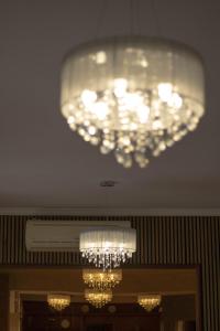 a chandelier hanging from the ceiling in a building at Hotel Marconi in Fiuggi