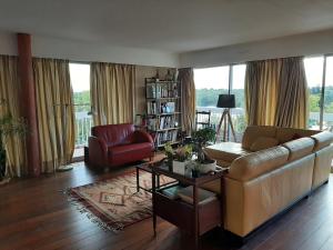 a living room with a couch and a chair at Chambre chez Casa Créteil in Créteil
