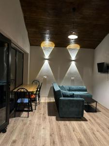 a living room with a couch and a table at Khimshura in Khimshi