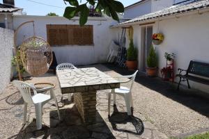 a patio with a stone table and two chairs at Studio Avec jardin privé in Bergerac