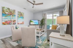 a living room with a couch and a tv at Dune Our Thing - Building A - 171 Washington condo in Fort Myers Beach