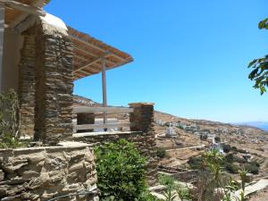 a stone house on the side of a hill at Tinian View Bee Home Maisonette in Arnados +8 photos