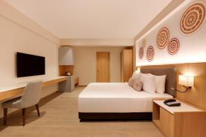 A television and/or entertainment centre at Lemon Tree Resort, Somnath