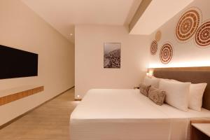 A television and/or entertainment centre at Lemon Tree Resort, Somnath