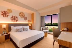 A bed or beds in a room at Lemon Tree Resort, Somnath