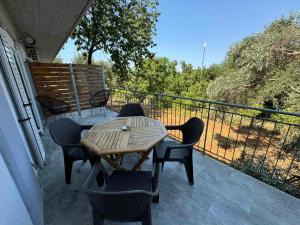 a patio with a table and chairs on a balcony at Alexander apartments in Spartià