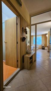a room with a bathroom with a large sliding glass door at Milushevi apartment in Golden Sands