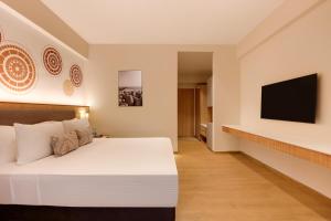 A bed or beds in a room at Lemon Tree Resort, Somnath