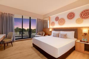 A bed or beds in a room at Lemon Tree Resort, Somnath
