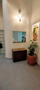 a room with a table and a plant and a mirror at La Maison des Amis in Fès +98 photos