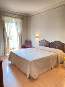 a bedroom with a large bed and a window at La Dimora di Pindaro in Colledimacine