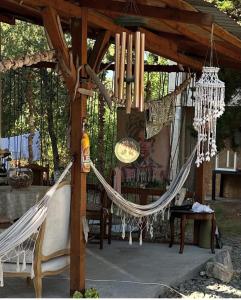 a hammock hanging from a wooden pergola at Forest house in Eforie Nord