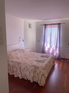 a bedroom with a bed and a window at Apartments Villa Dinka in Opatija