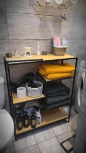 a shelf in a bathroom with towels on it at Apartament ,,Kraina Alicji'' in Wałbrzych