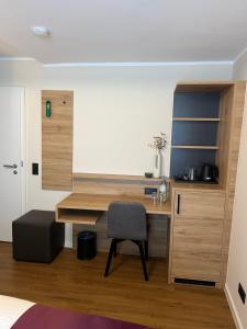 a bedroom with a desk and a chair in a room at Hotel Restaurant Wolfsschlucht GmbH in Bad Münstereifel