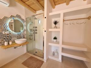 a bathroom with a shower and a sink at Villa Iasmos in Pitsidia +31 photos