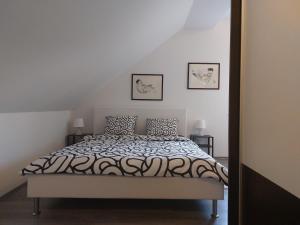 a bedroom with a bed and two pictures on the wall at Apartment Cedar Zagreb Airport - Velika Gorica in Ščitarjevo