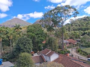 a view of the mountains from a house at Apartamento Centro ao lado do Country Club in Nova Friburgo