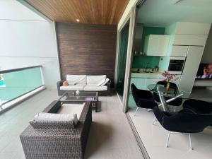 a living room with a couch and a table at Ananya Beachfront Wongamat Paradise in North Pattaya +17 photos