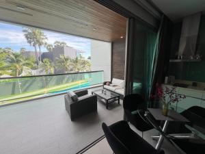 a living room with a large window with a view at Ananya Beachfront Wongamat Paradise in North Pattaya