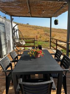 a table and chairs on a deck with a swing at Casa vacanze Trinacria in Menfi +35 photos