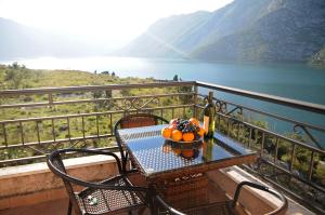 a table with a bowl of fruit on a balcony at Apartments Risan Club Family in Risan